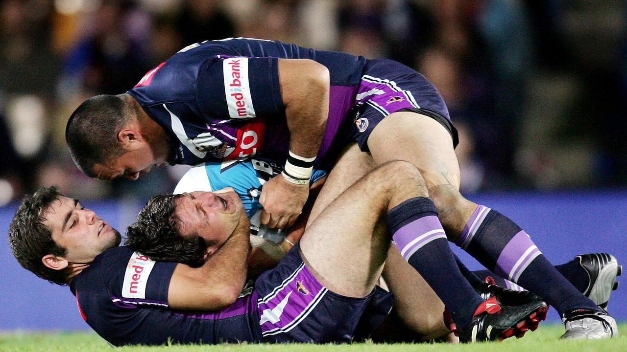 Cam Smith chokes Jason Stevens in a grapple tackle.