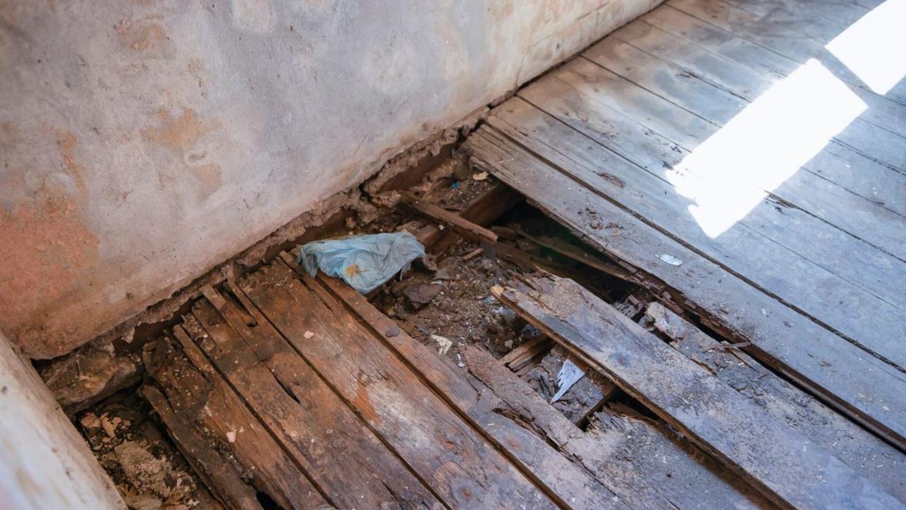 Cracked floorboards make the property unsafe to walk in without foot protection.