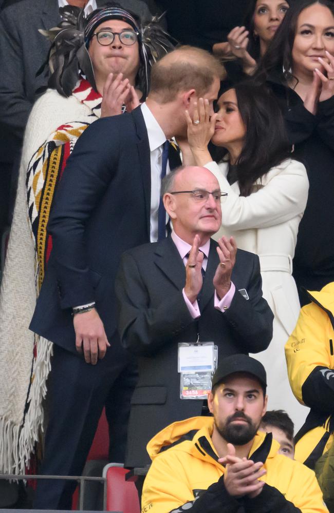 Meghan Markle plants a huge kiss on Prince Harry’s lips. Picture: WireImage