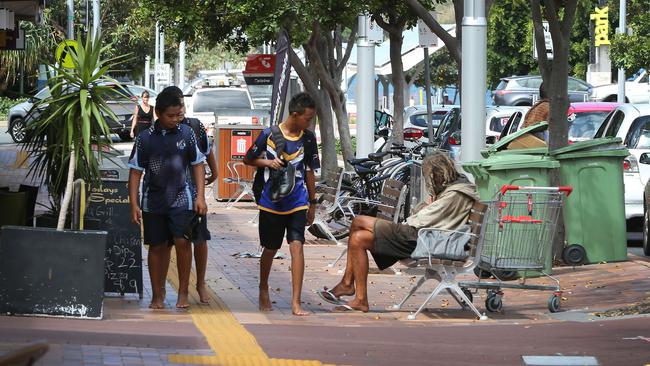 Kids and a transient man in Nerang Street. Picture Glenn Hampson