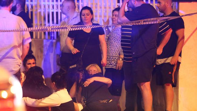 Loved ones embrace at the scene of the fatal shooting. Picture: Wayne Taylor.