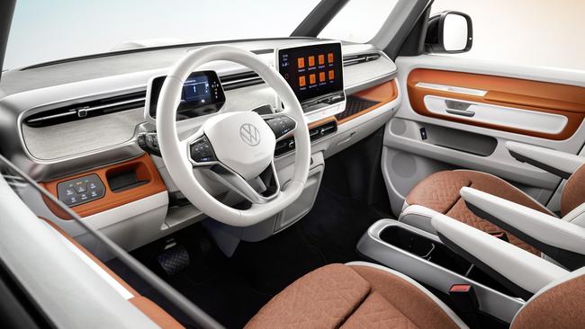 The cabin features a small digital driver display and large central touchscreen.