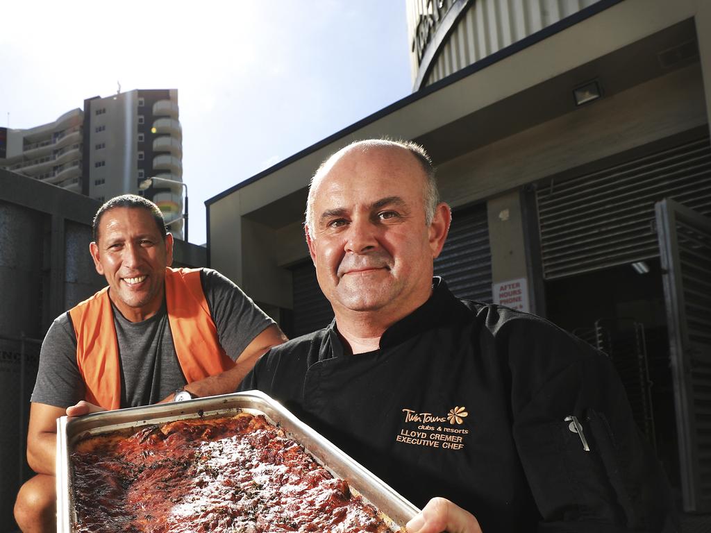 Twin Towns executive Chef Lloyd Cremer delivering a tray of lasagne to Vibe Church senior pastor David Nahi.