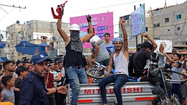 Gazans celebrate the return of Hamas fighters after their murder and kidnapping of Israeli civilians on October 7. Picture: AFP