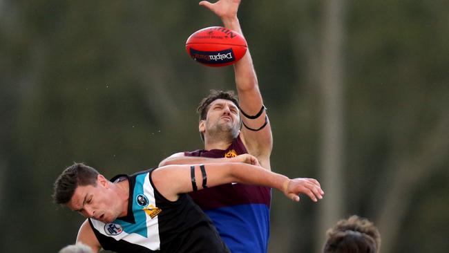 Ruckmen from Banyule and St Mary’s content a tap out. Picture: Stuart Milligan.