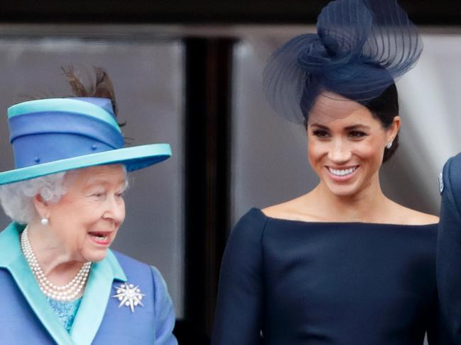 LONDON, UNITED KINGDOM - JULY 10: (EMBARGOED FOR PUBLICATION IN UK NEWSPAPERS UNTIL 24 HOURS AFTER CREATE DATE AND TIME) Queen Elizabeth II, Meghan, Duchess of Sussex and Prince Harry, Duke of Sussex watch a flypast to mark the centenary of the Royal Air Force from the balcony of Buckingham Palace on July 10, 2018 in London, England. The 100th birthday of the RAF, which was founded on on 1 April 1918, was marked with a centenary parade with the presentation of a new Queen's Colour and flypast of 100 aircraft over Buckingham Palace. (Photo by Max Mumby/Indigo/Getty Images)