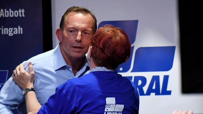 Tony Abbott receives a kiss from his sister in law Virginia Flitcroft after conceding defeat in at Manly Leagues Club in Brookvale. Picture: AAP