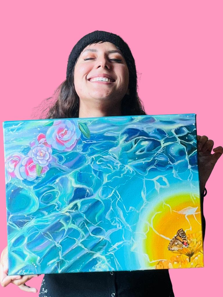 Tasmanian artist Brandi Salmon with a painting she did for pop superstar Lorde. Picture: Supplied