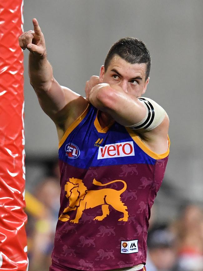 Tom Rockliff of the Lions celebrates kicking a goal by kissing his armband in honour of his cousin. Picture: AAP Image/Darren England