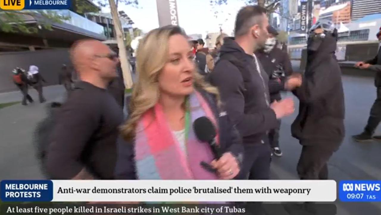 A protester and an ABC security guard got into a scuffle live on air. Picture: ABC 24