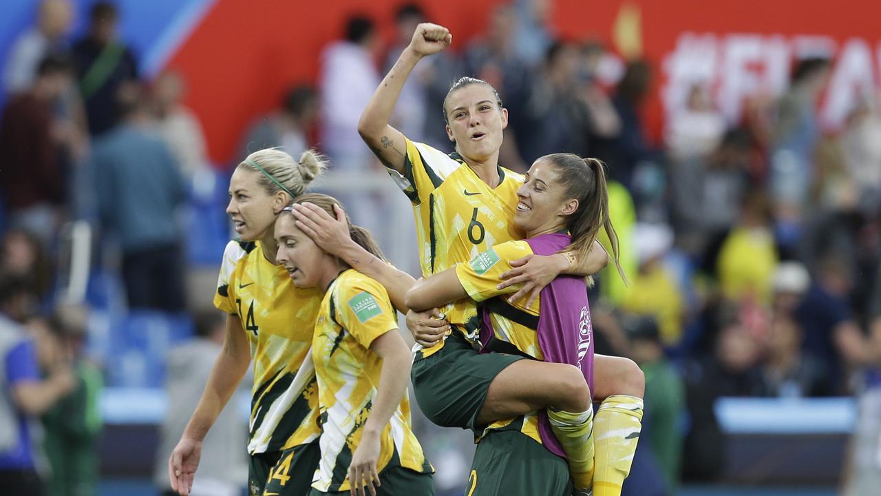 Australia's Chloe Logarzo, top, celebrates with teammates
