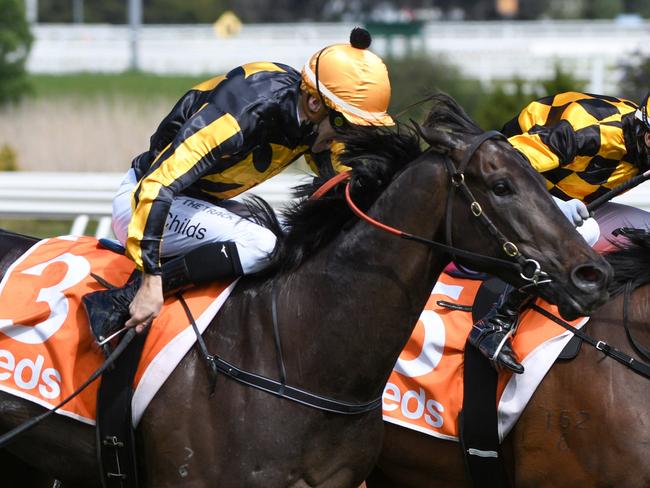 MELBOURNE, AUSTRALIA - OCTOBER 09: Brett Prebble riding Probabeel defeats Jordan Childs riding Nonconformist in race 6, the Neds Might And Power, during Melbourne Racing at Caulfield Racecourse on October 09, 2021 in Melbourne, Australia. (Photo by Vince Caligiuri/Getty Images)