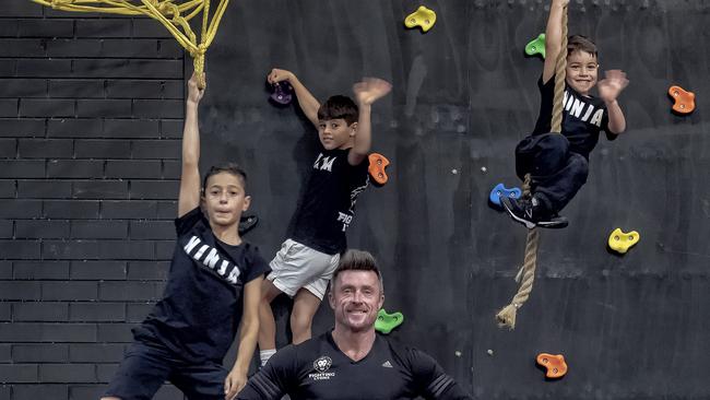 Coach Paul Lyons at his gym Fighting Lyons with Daniel, Julian and Jude Saccuzzo. Picture: Luis Enrique Ascui