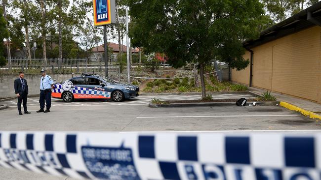 NSW police are seen near a backpack and knives at a shopping centre adjacent to Bonnyrigg High School. Picture: (AAP Image/Dan Himbrechts)