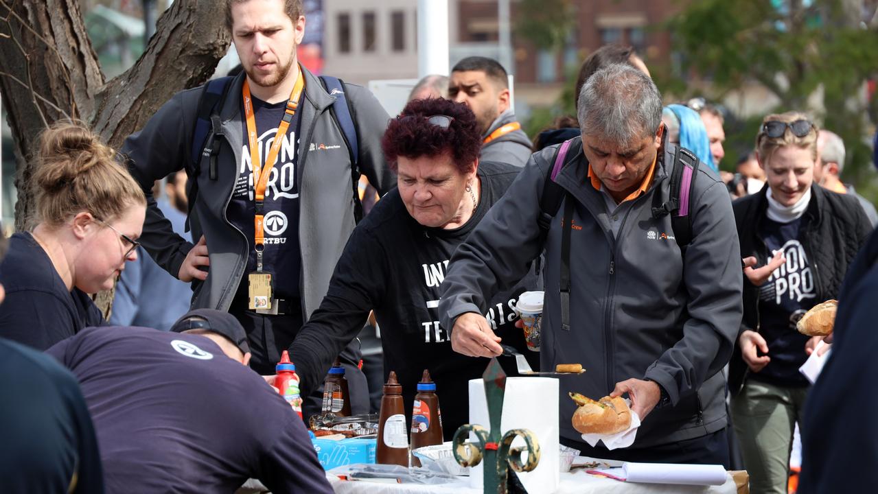 Union members hooked into hot sausage sandwiches before embarking on an organised march around the city. Picture: NCA NewsWire / Nicholas Eagar