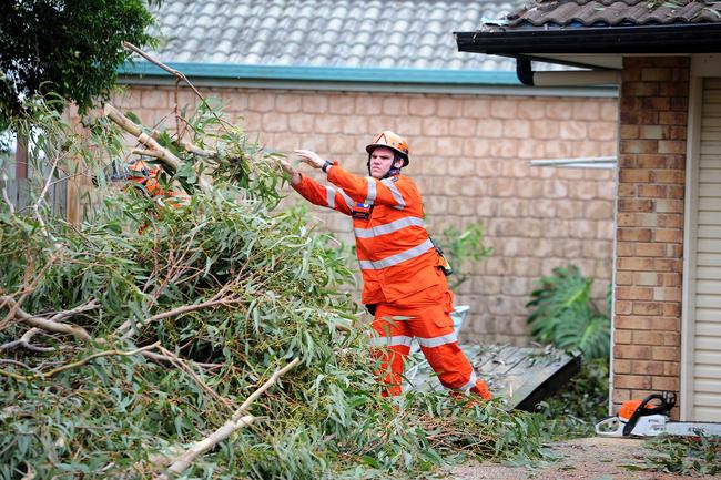 SES hard at work cleaning up the mess in Little Mountain following ferocious storm on Saturday. Picture: John Gass