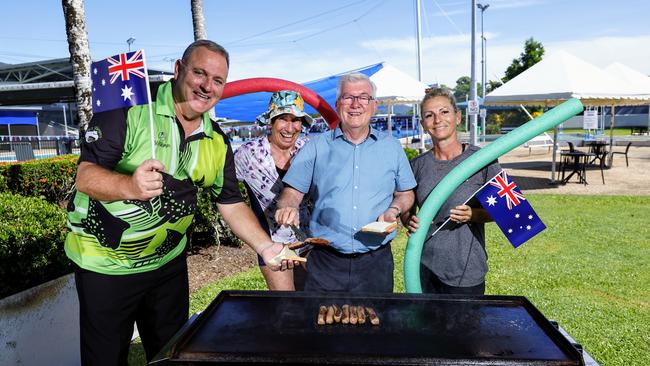 Cairns Regional Council is busy preparing three family fun days at council swimming pools on Australia Day, with Woree Sports and Aquatic Centre hosting a council event for the first time. Cairns Stingrays swimming club president Jason Salecich and aqua aerobics participant Joy Brown get served an Australia Day Sausage from Cairns Mayor Terry James as Aquafit instructor Karen Skudder watches on. Picture: Brendan Radke