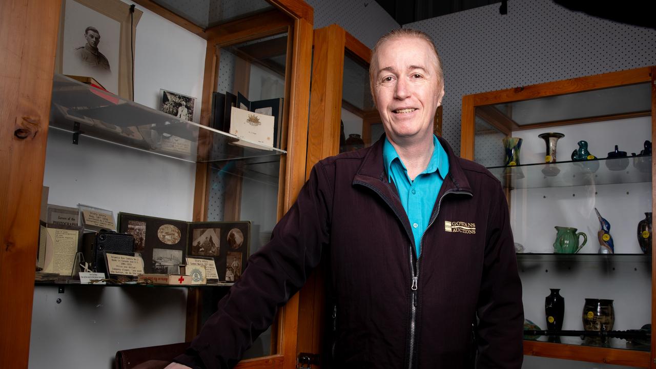 Auctioneer Scott Seymour at Gowans Auctions in Moonah with some of the World War I artefacts that are up for auction. Picture: Linda Higginson