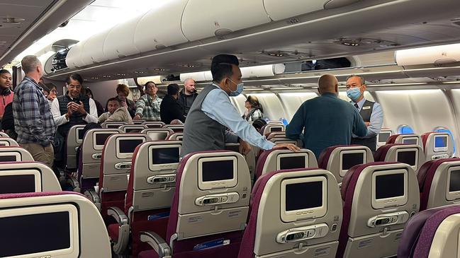 Flight staff talk to the man on the tarmac in Sydney. Picture: Supplied