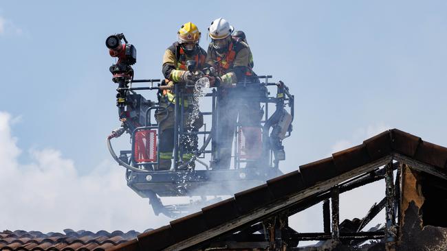 Firefighters at the scene of a fatal house fire at Bayside Court, Thorneside. Picture: Lachie Millard