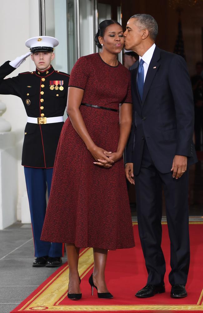 President Barack Obama and First Lady Michelle Obama kiss as they prepare to greet President-elect Donald Trump and his wife Melania to the White House in Washington, DC on January 20, 2017. Picture: AFP
