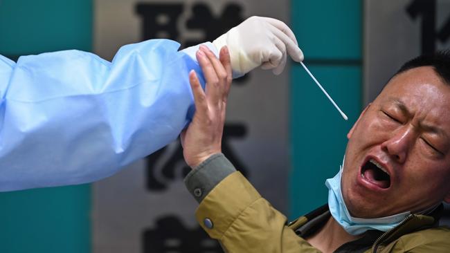 A medical worker takes a swab sample in Wuhan in China's central Hubei province in 2020. Picture: AFP