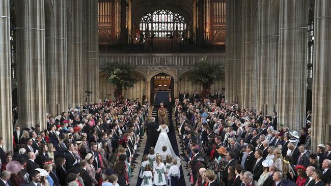 Britain's Princess Eugenie walks down the aisle with her father Prince Andrew. Picture: AP