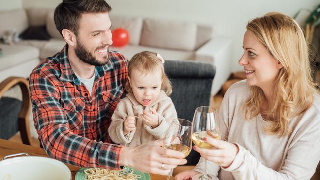 Young parents with a child having Italian food at home. Picture: iStock