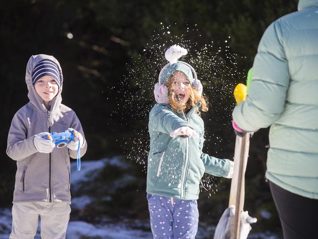 Lars and June Cluck, both 5, enjoying the snow on Mt Wellington/kunanyi. Picture: RICHARD JUPE