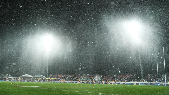 Snow tumbles down as the Giants and Hawks battle it out. Picture: AFL Photos/Getty Images