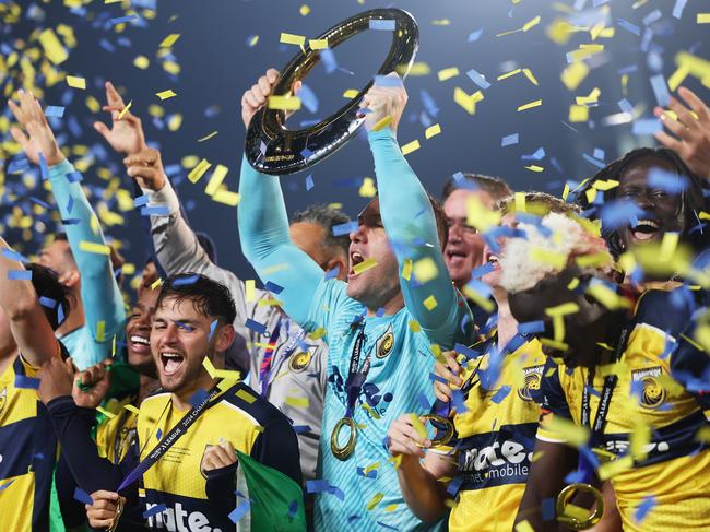 GOSFORD, AUSTRALIA - MAY 25: Danny Vukovic of the Central Coast Mariners holds aloft the Championship Trophy alongside team mates after winning the A-League Men Grand Final match between Central Coast Mariners and Melbourne Victory at Industree Group Stadium, on May 25, 2024, in Gosford, Australia. (Photo by Mark Metcalfe/Getty Images)