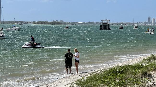 Onlookers at a GC beach as multiple search and rescue teams search for missing Gatton man Gavin Krenske.