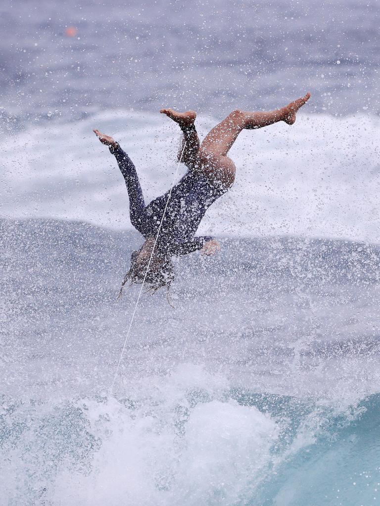 Australian junior female surfer Molly Picklum takes off on a wave at Burleigh point as wet weather descended over the Gold Coast. Photo: Scott Powick NEWSCORP