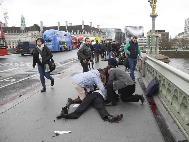 Injured people are assisted after an attack on Westminster Bridge in London. Picture: Reuters