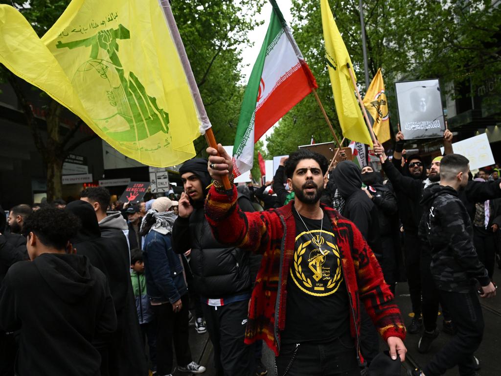 A pro-Palestine protester waves a Hezbollah flag at a rally in Melbourne. Picture: James Ross