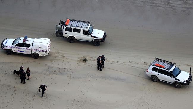 Authorities on the beach after a suspected asylum seeker boat arrived off the Queensland coast. Picture: Marc McCormack