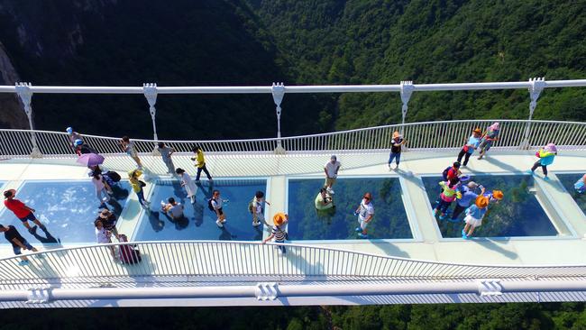 Some of the bridge’s first visitors check out the scenery after it opened on August 20. Picture: Chinatopix via AP