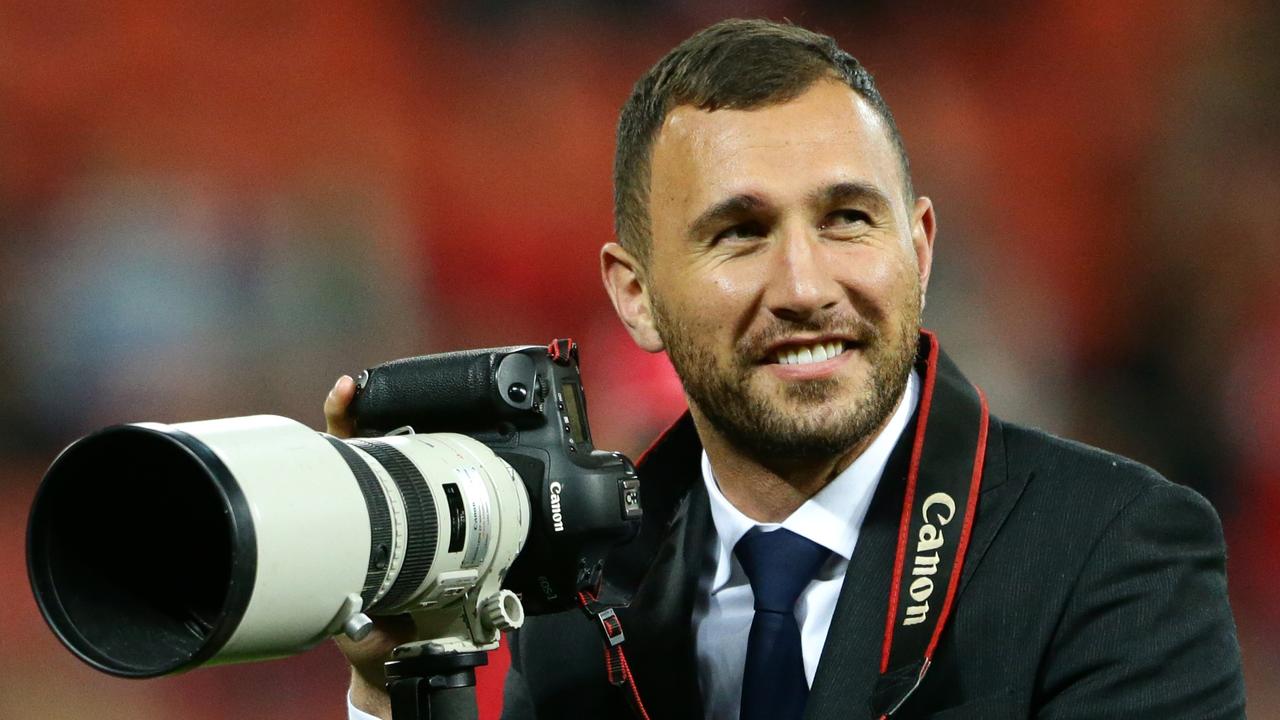 Quade Cooper borrows a camera before the Super Rugby match between the Queensland Reds and the New South Wales Waratahs. Pic Darren England.