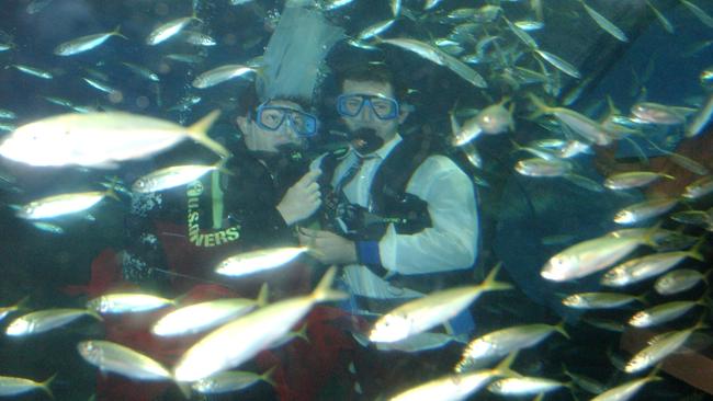 Jason Smith and Janelle Brown surrounded by a school of fish, in the shark tank at Sea Life Sunshine Coast in 2002. Picture: Lou O'Brien