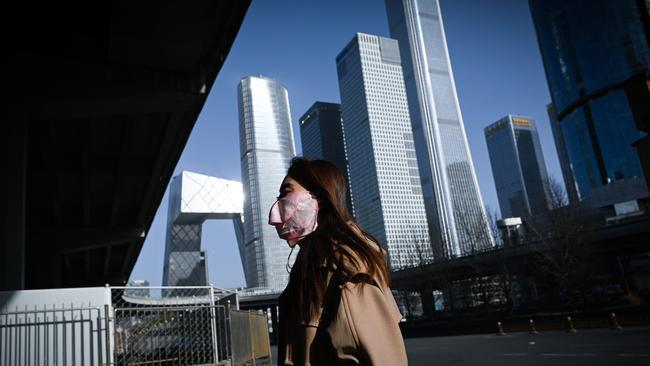 A woman walks in the central business district in Beijing. Picture: AFP