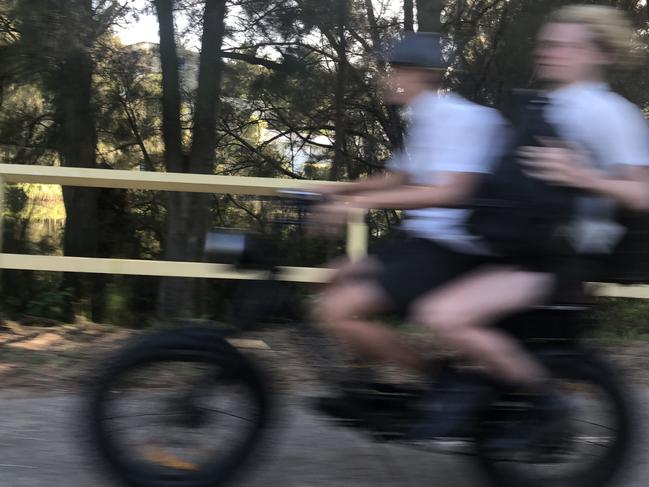 Secondary schools students on an e-bike on a shared bike/pedestrian path on Pittwater Rd, Manly. Picture: Jim O'Rourke