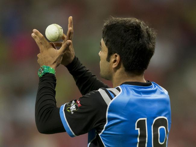 Rashid Khan of the Strikers catches Chris Green. Picture: AAP / Craig Golding