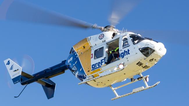 A CareFlight Rapid Response helicopter landed at St Matthews Farm Reserve at Cromer on Monday afternoon to allow a specialist trauma doctor to help ambulance paramedics treat and stabilise a woman, 77, who had bee hit by a ute while crossing South Creek Rd at Wheeler Heights. Picture: CareFlight