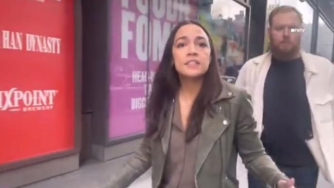 The protesters, still filming, followed Ms Ocasio-Cortez and her fiance out into the street.