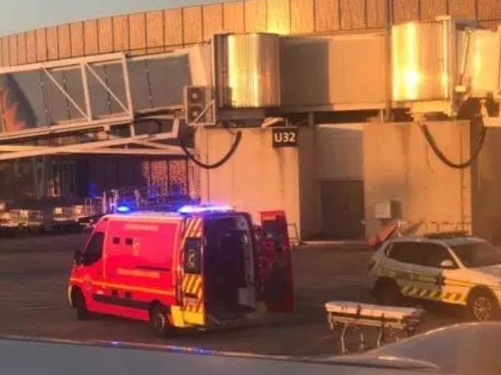 An ambulance waits for a British man at an airport in Toulouse, France, after he suffered a medical emergency on a flight to Ibiza.