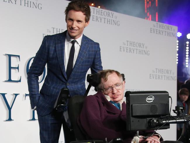 FILE - In this Tuesday, Dec. 9, 2014 file photo, Professor Stephen Hawking, right, and cast member Eddie Redmayne arrive on the blue carpet for the UK premiere of 