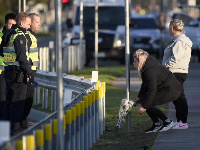 Mourners bring flowers to the scene of the Thompsons Road fatality. Picture: Andrew Henshaw