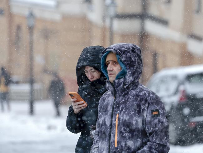 Members of the public walk through the snow in Ukraine as Russian attacks on the power grid cause cuts to electricity, heating and water. Picture: Jeff J Mitchell/Getty Images