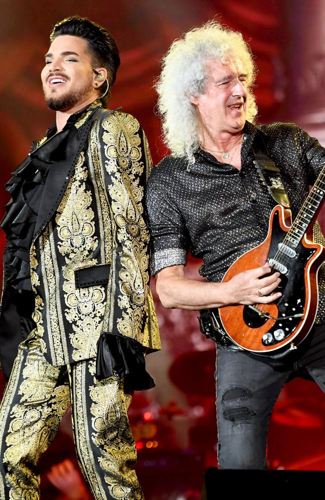 Adam Lambert and Brian May of Queen perform onstage.