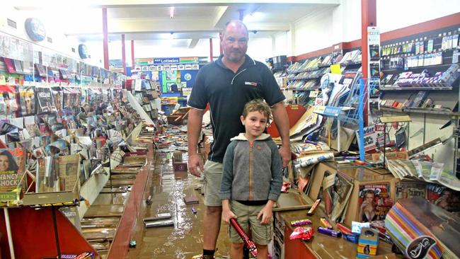 Keiran Scott and his son Sebastian have a long road ahead to clean up their newsagency in Molesworth St, Lismore. Picture: Alison Paterson